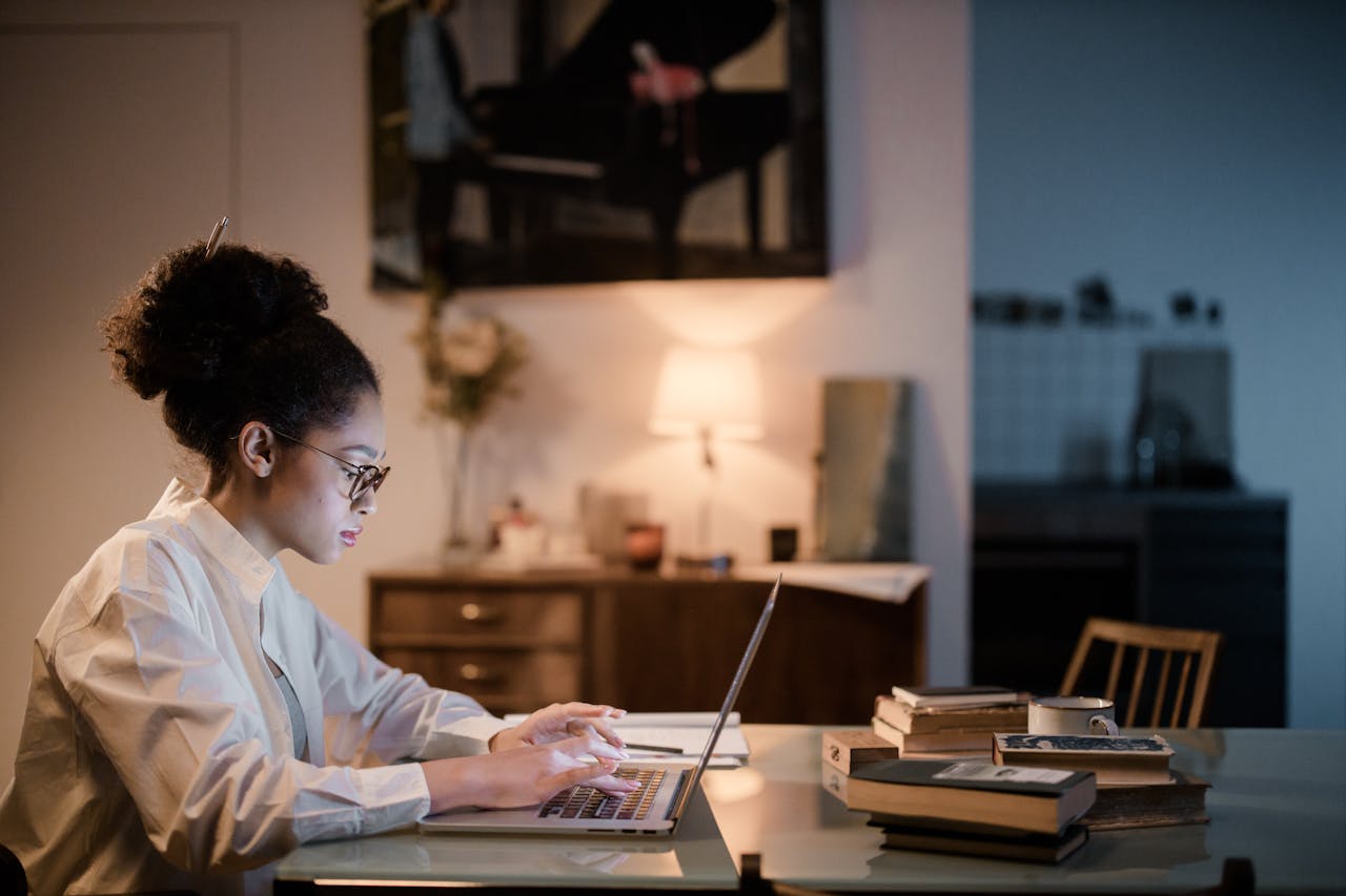 A young woman concentrating on her laptop in a cozy home setting having a virtual therapy session.
