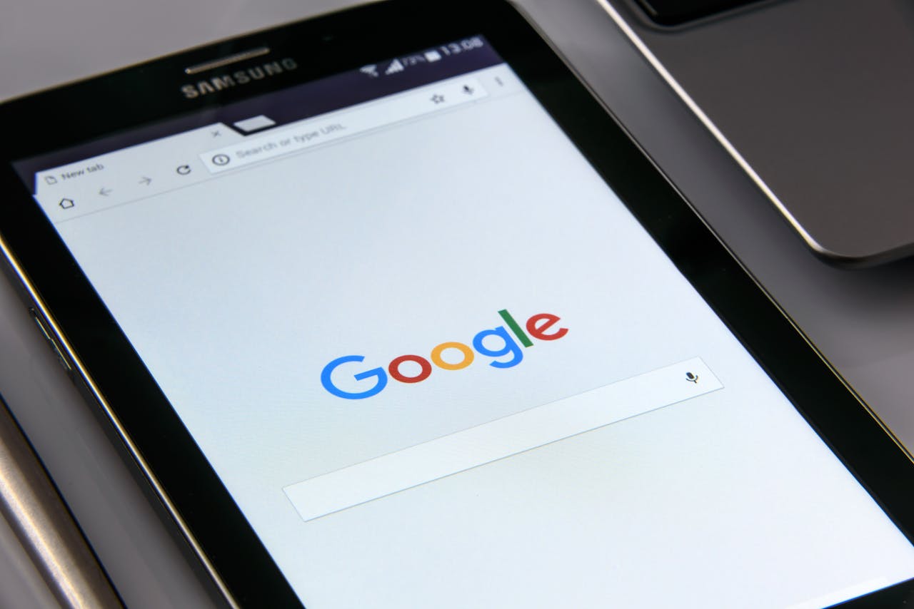 Close-up of a tablet displaying Google's search screen, and internet browsing.