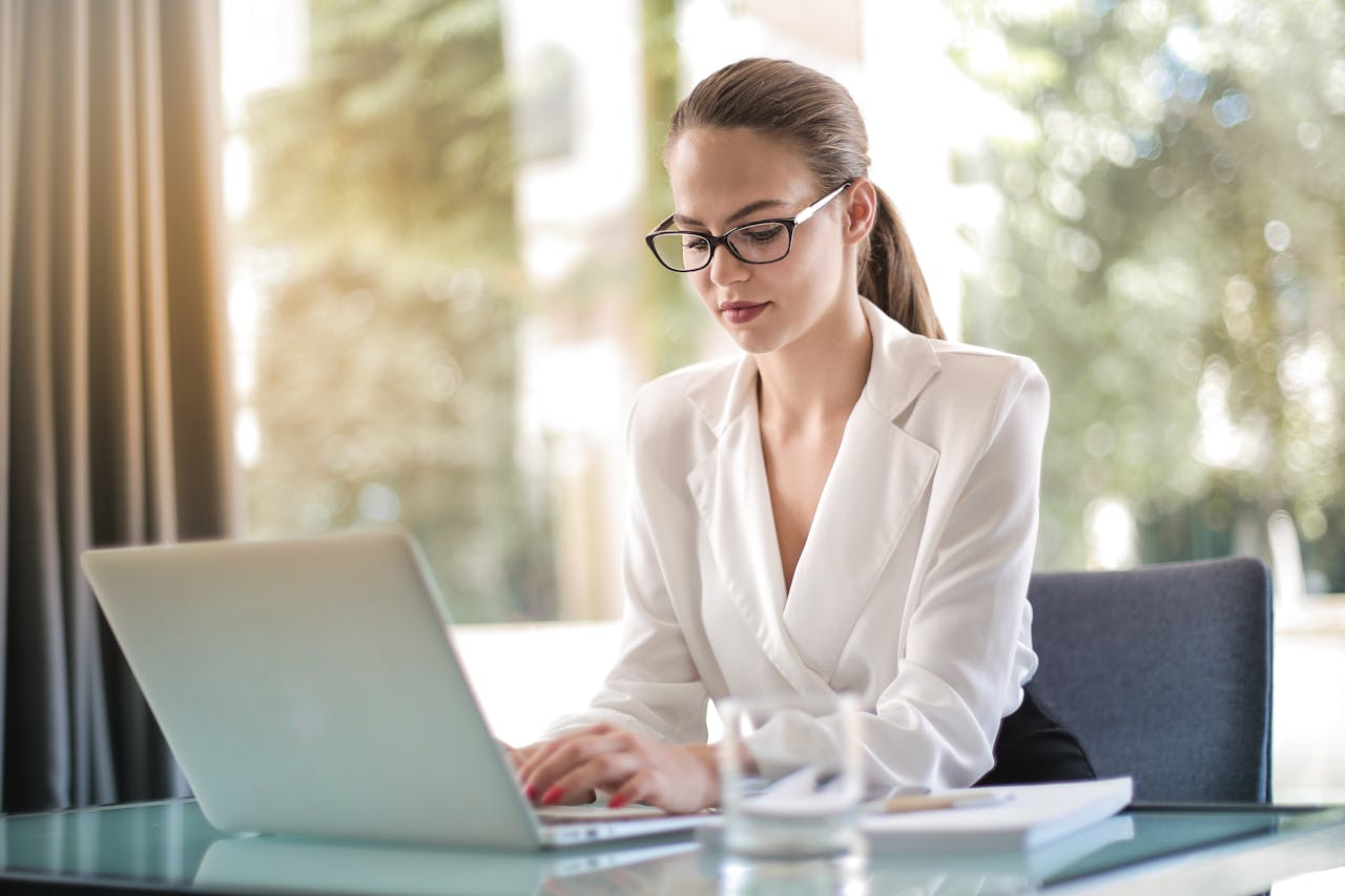 Woman having online therapy using a laptop at a desk.
