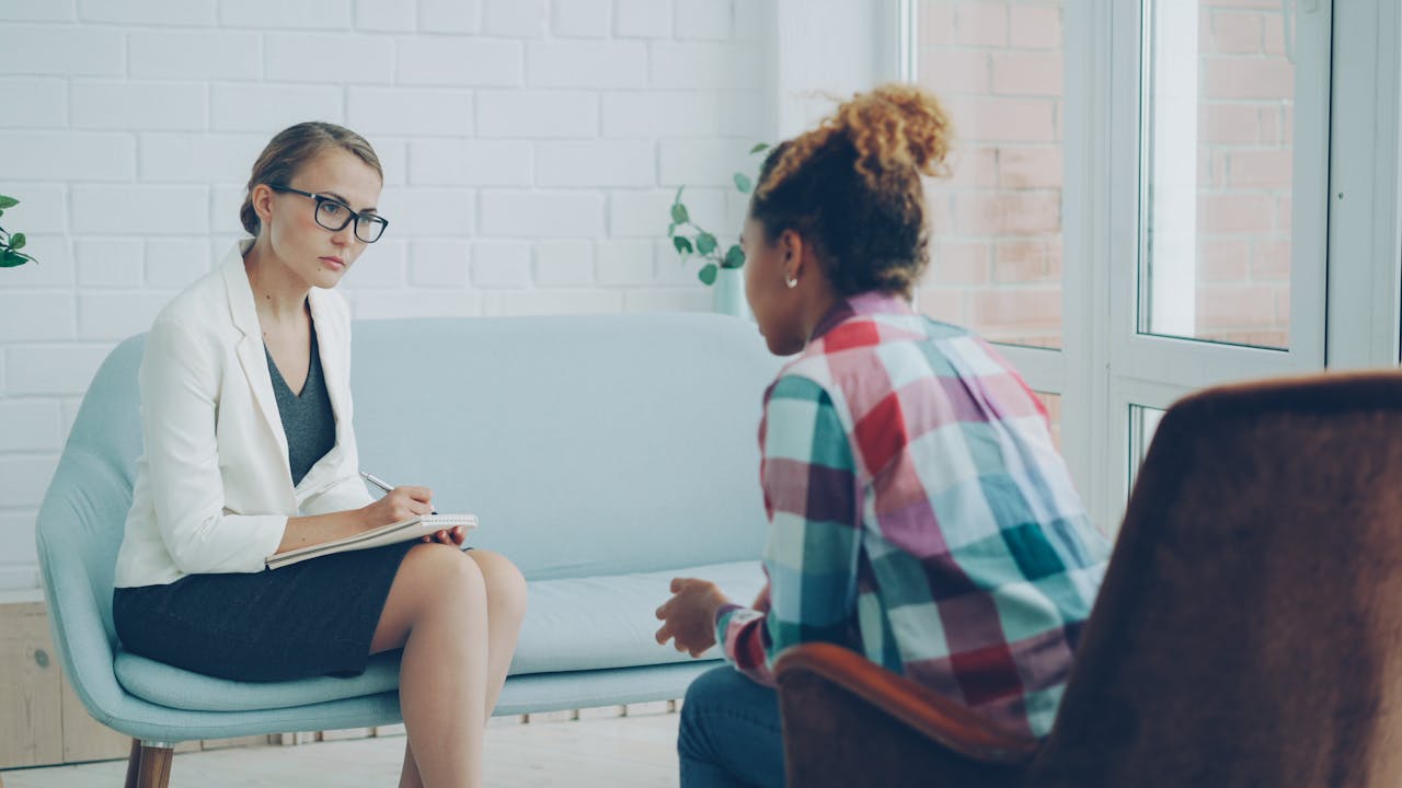 A therapist listens attentively during a private assessment counseling session.